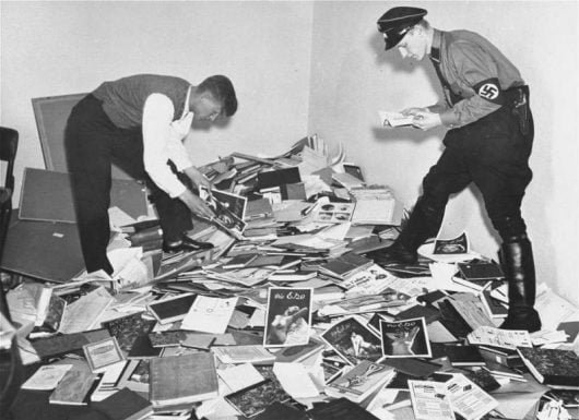 A Nazi student and a member of the SA plundering the Institute for Sexual Science in Berlin (May 6, 1933). Photo: U.S. National Archives and Records Administration.